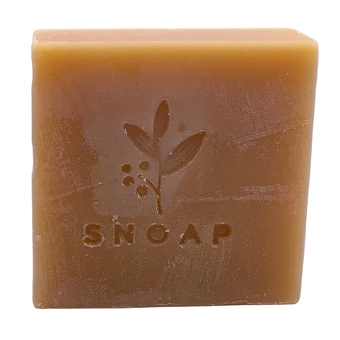 The image shows a bar of soap called "Snoap tea tree soap" from the front side.