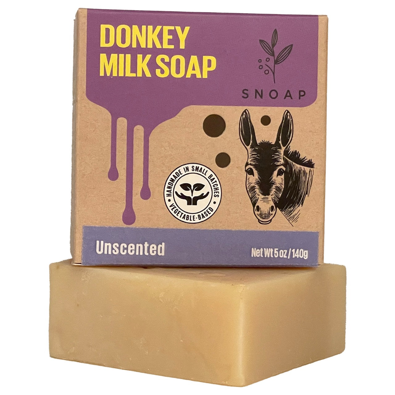 A bar of unscented donkey milk soap with a light tan color is stacked below its cardboard box packaging. The box is decorated with a sketch of a donkey and the text 'Donkey Milk Soap' and 'SNOAP'.